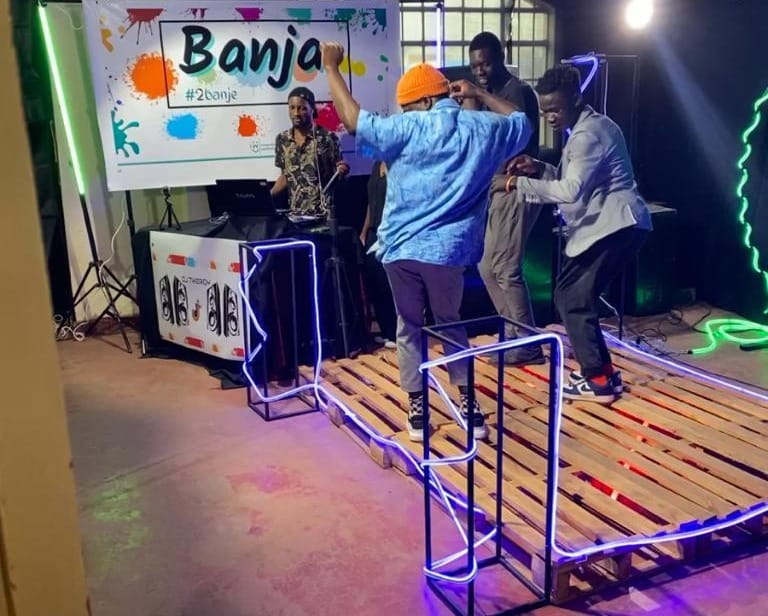 Image of a few people dancing on a makeshift dance floor