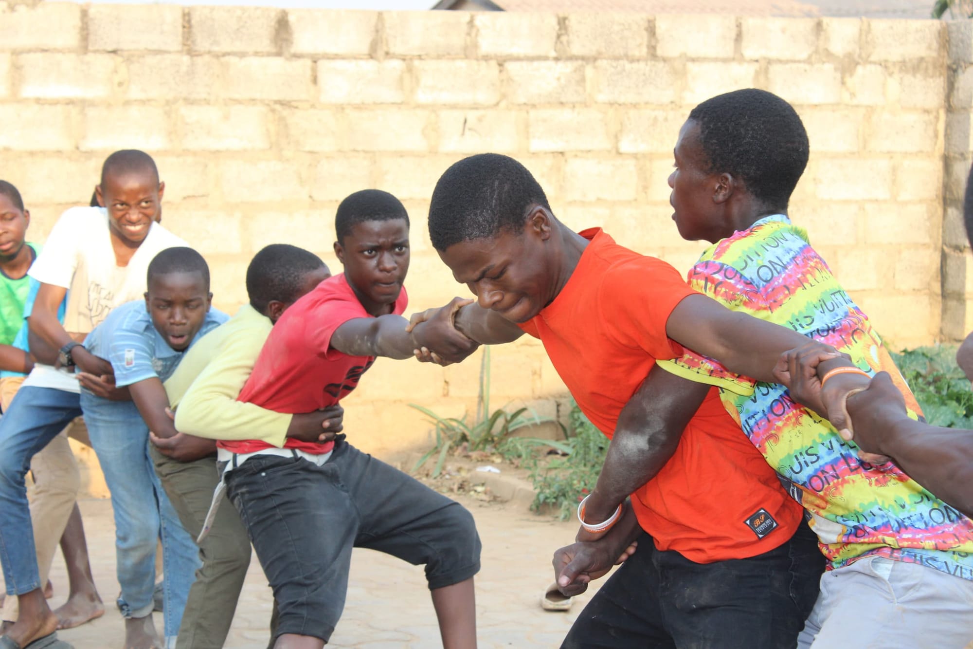 A group of boys engaging in a tug-of-war activity